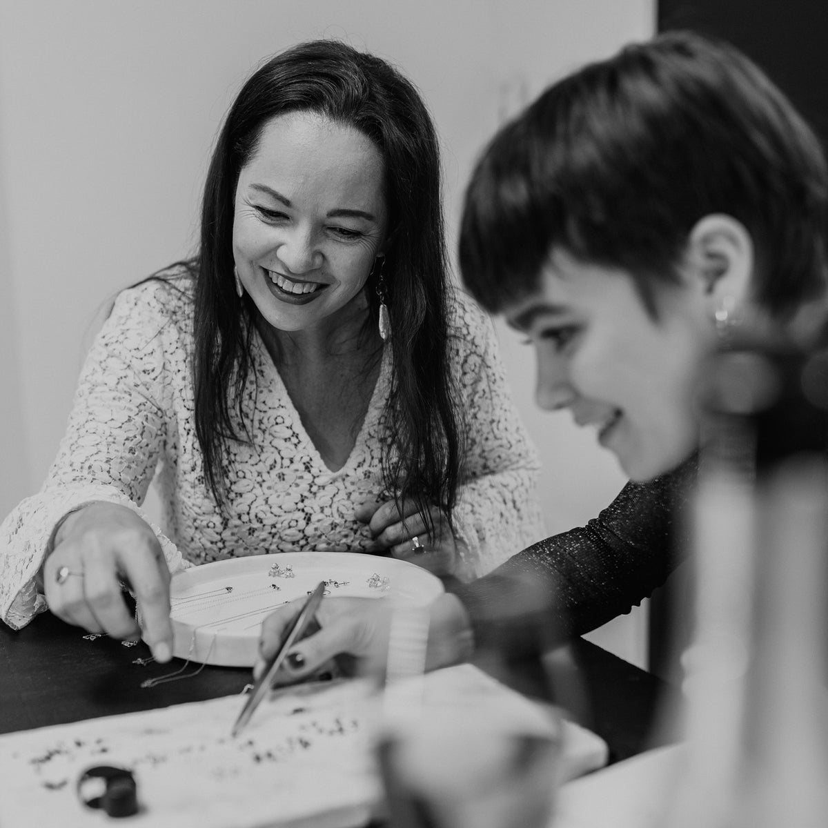 A designer and client laughing over a sketch