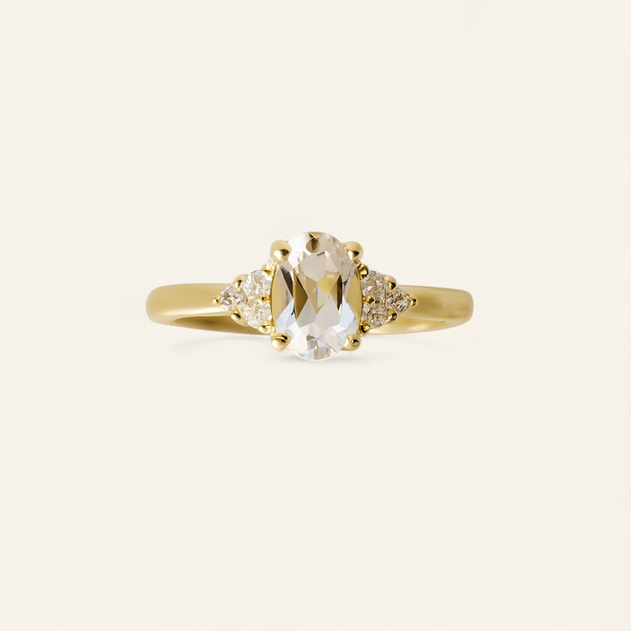 Oval cut diamond ring accented with three smaller diamonds on each side