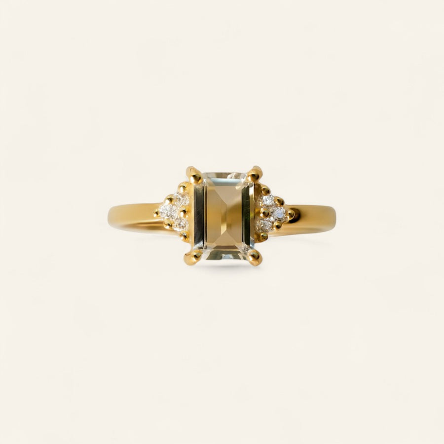 Rectangle cut diamond ring accented with three smaller diamonds on each side