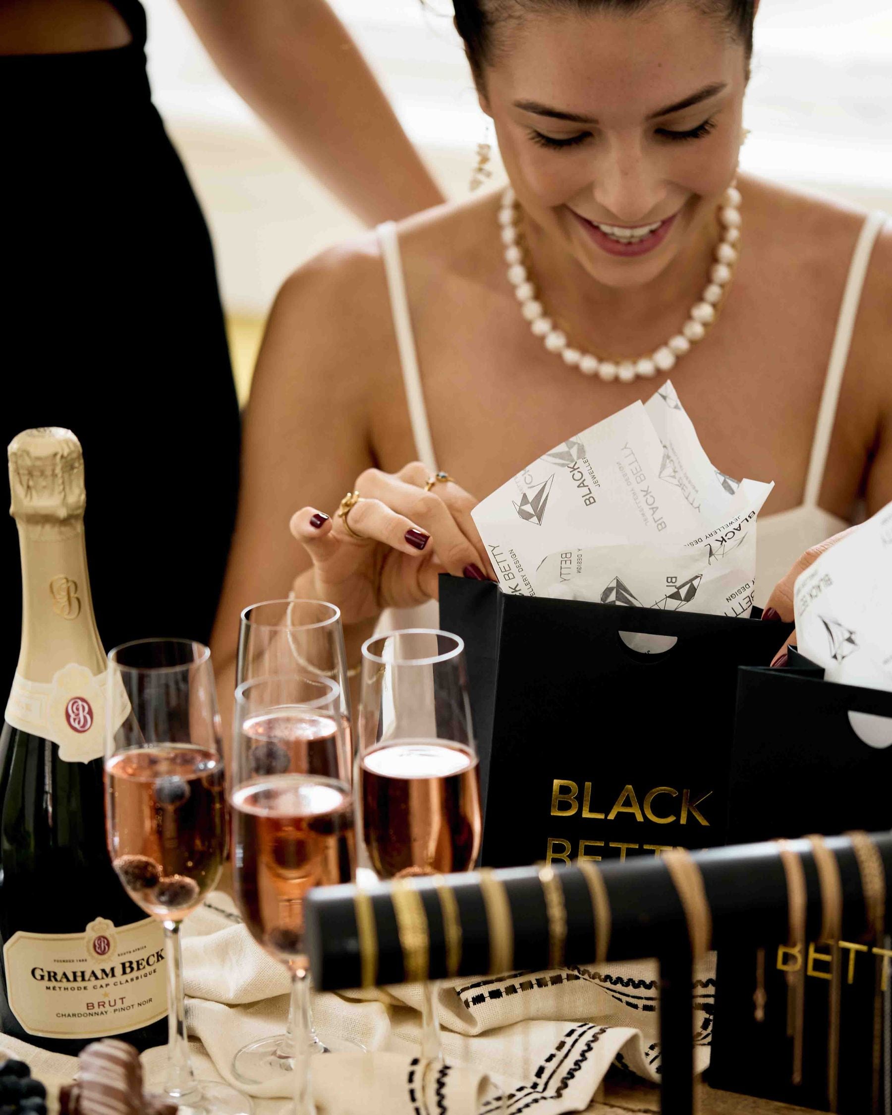 A guest opening a Black Betty gift bag