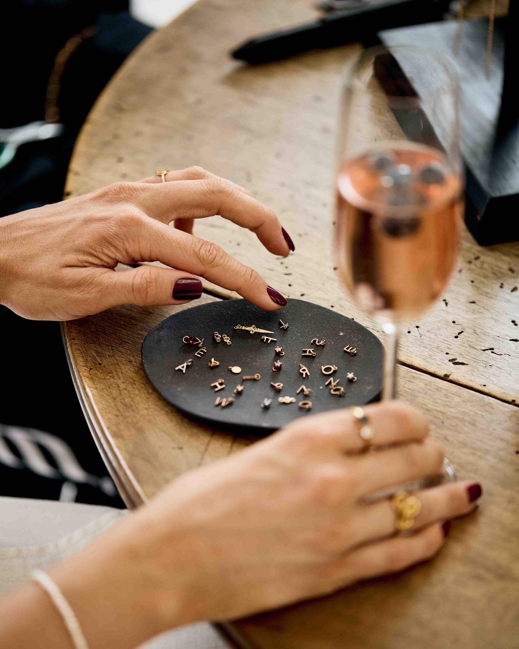 Choosing piercing studs from a dish at the studio