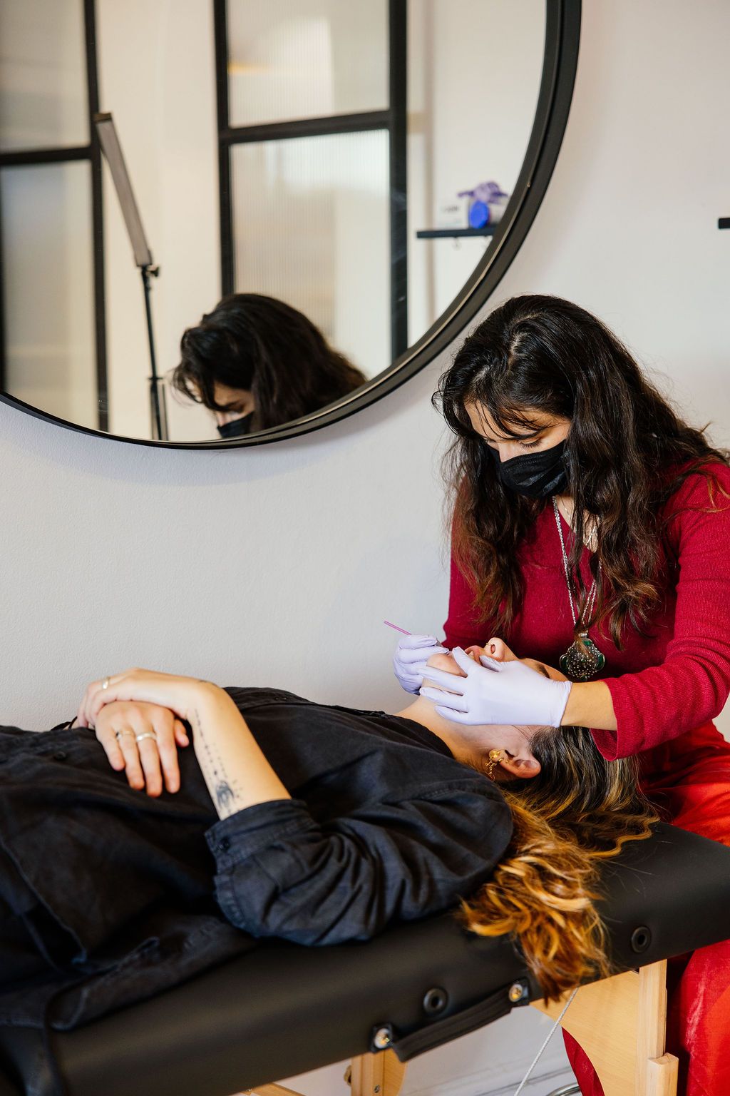 A Black Betty piercer at work, gloved and masked